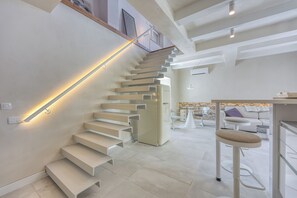 A modern interior with a staircase, a bar area, and a seating area. - 1BR Star Wars Inspired Duplex Loft /w Sea View (Mali Losinj)