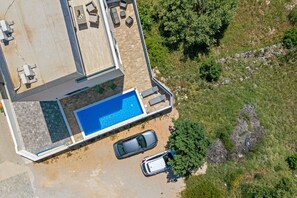 An aerial view of a property with a swimming pool, two cars, and a patio area. - Villa Ana Pool & Terrace (Vodice)