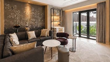 Una sala de estar moderna con un sofá, sillones, una mesa de centro y un adornado en la pared.