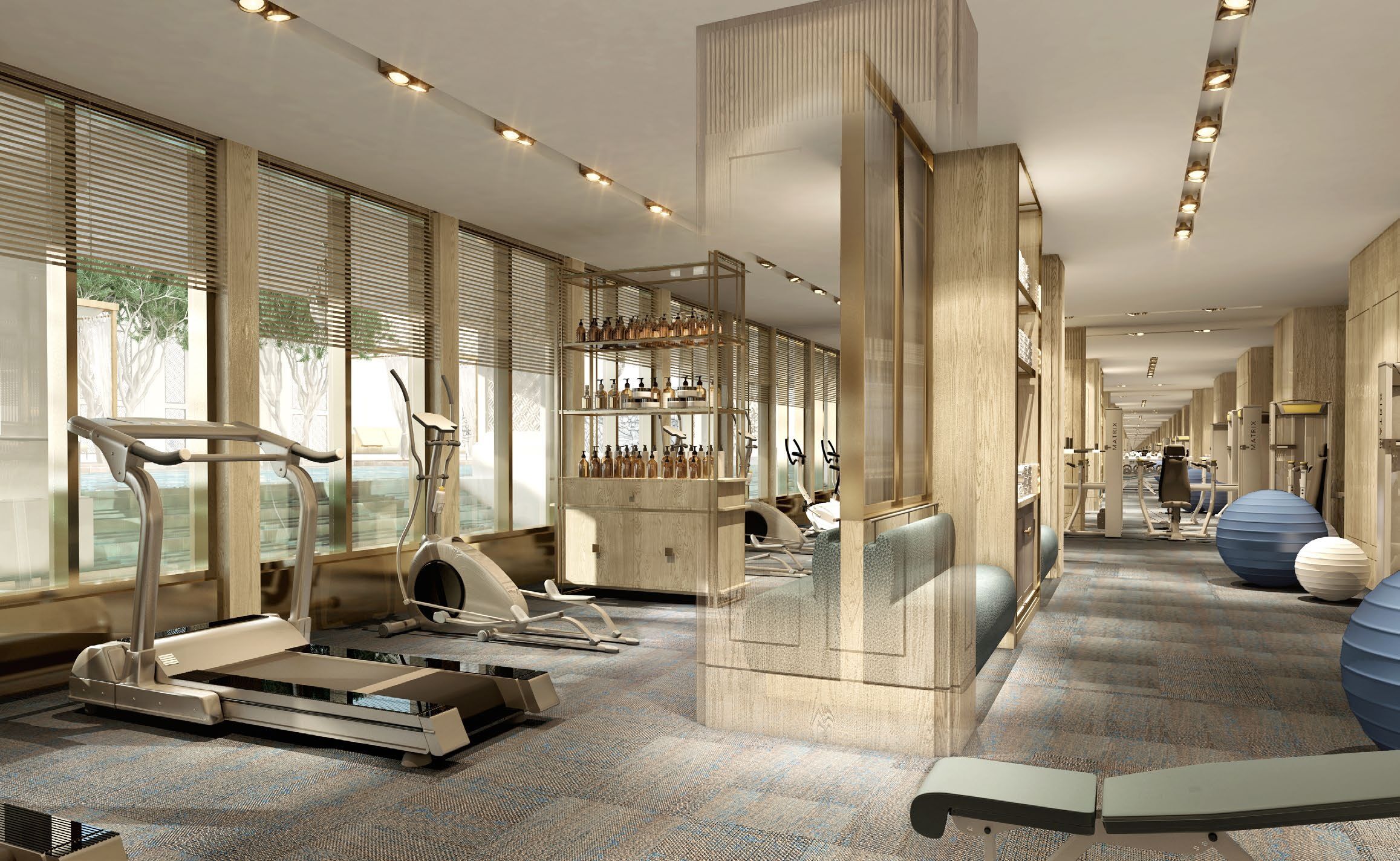 Un gimnasio moderno de hotel con equipamiento de ejercicio, ventanas amplias y un diseño espacioso.
