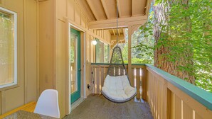 A wooden porch with a hanging chair, a door, and a window. - Quiet Condo Next to Enchantment, Adventure Parks (Leavenworth)
