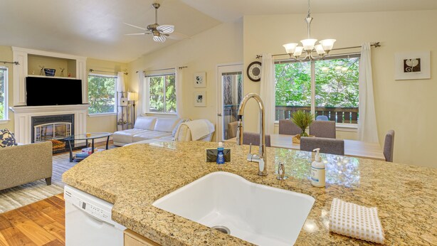 A kitchen with granite countertops, a white sink, and a dishwasher. - Quiet Condo Next to Enchantment, Adventure Parks (Leavenworth)
