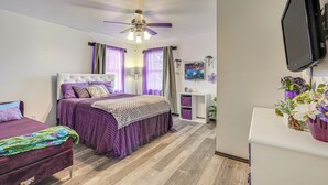 A bedroom with a bed, a desk, a TV, and a ceiling fan. - Panama City Fall Getaway: Pool & Near Events (Panama City)