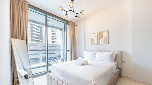 Une chambre d’hôtel moderne avec un grand lit, une vue sur la ville et un balcon.