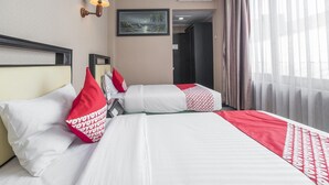 A hotel room with two beds, a painting on the wall, an air conditioner, and a window with curtains. - Twin Escape Near Losari Beach (Makassar)