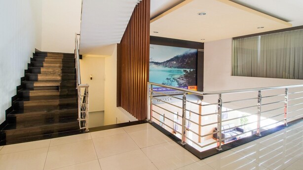 A modern interior with a staircase, a flat-screen TV, and a railing.
