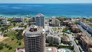A coastal urban area with high-rise buildings, a marina, and a swimming pool. - #357 Sea View Getaway in Portimão | Pool & Spacious (Portimão)