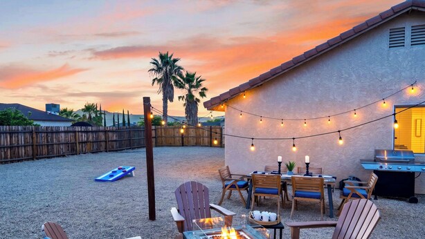 A patio area with outdoor seating, a fire pit, and a barbecue grill. - Pool + Firepit + BBQ | Near Park + DT Yucca Valley |  The Light of the Desert (Yucca Valley)