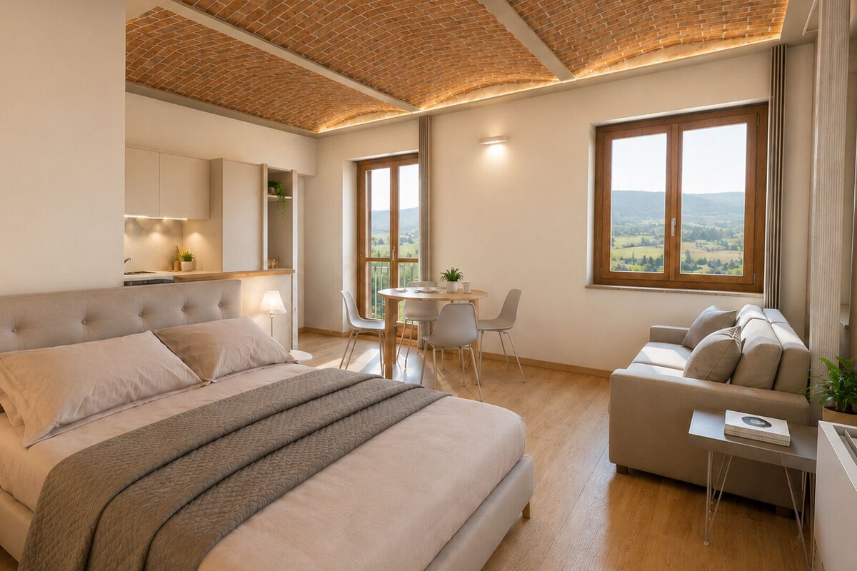 A modern bedroom with a large bed, a sitting area, and a view of the outdoors.
