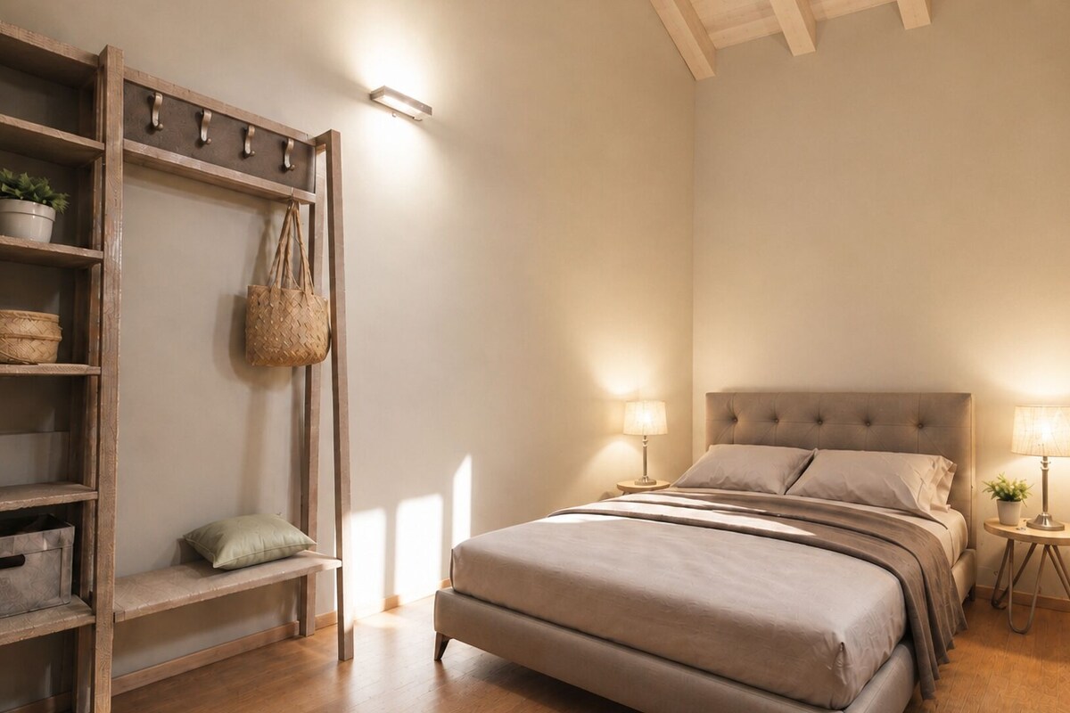 A bedroom with a bed, bedside tables, a wooden shelf unit, and a hanging basket.