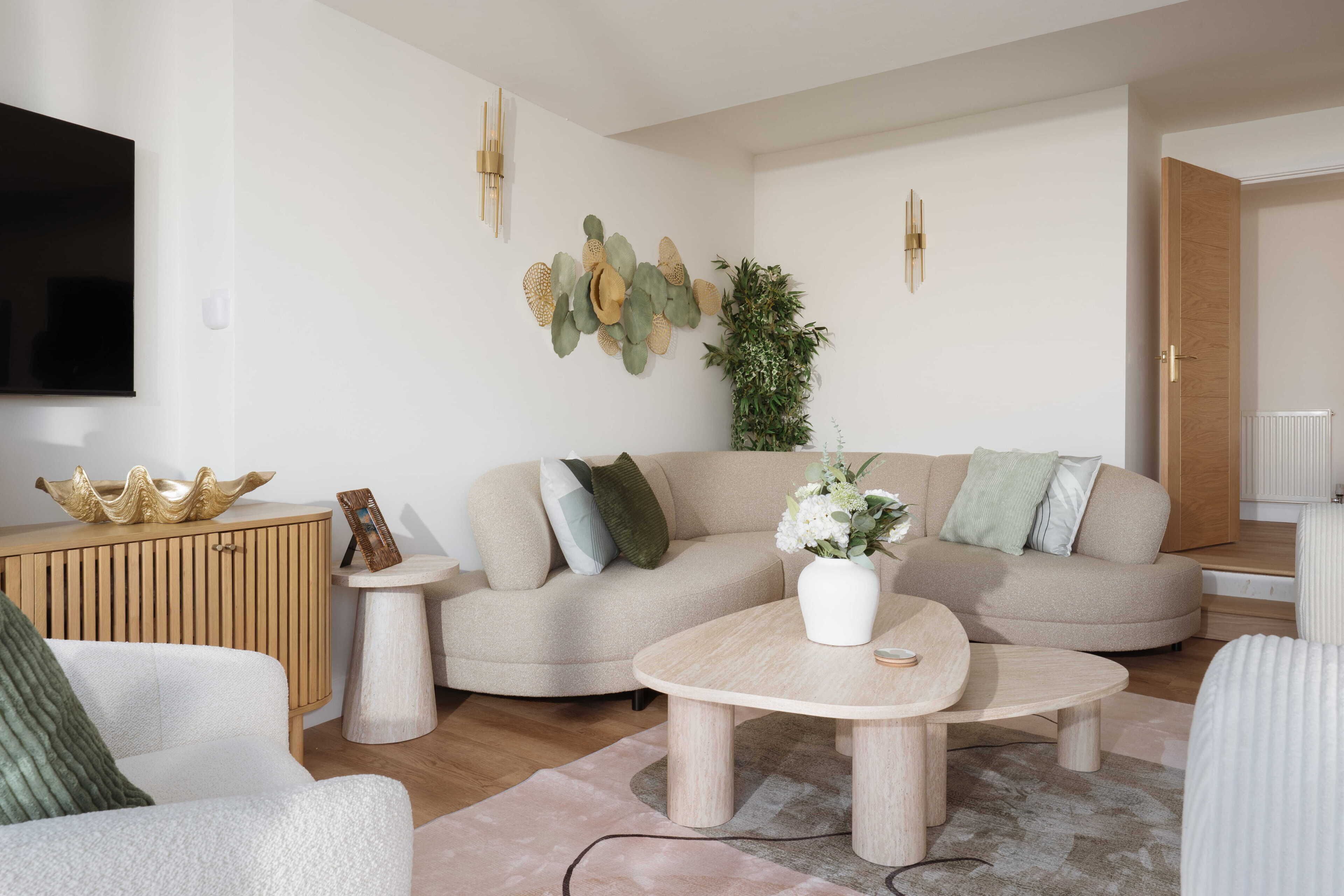 A modern living room with a sofa, coffee table, and a television.