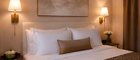 A hotel room with a bed, two bedside lamps, a nightstand with a vase of flowers, and a painting on the wall.
