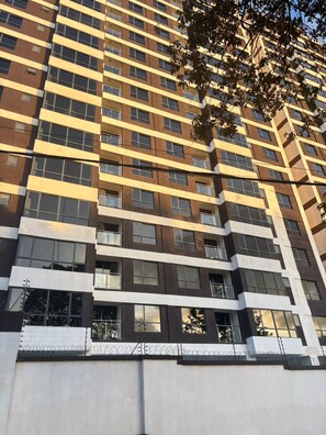 A high-rise building with a modern architectural design, featuring multiple floors and a uniform facade. - west suites studios nairobi west (Nairobi)