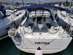 A marina with a boat named 'FORTUNA' docked.