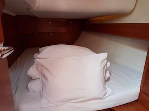A bunk bed with white bedding, wooden headboard, and a metal handle. - Sun-Kissed Sailing: An Unforgettable Beach Experience in Istria, Croatia (Medulin)