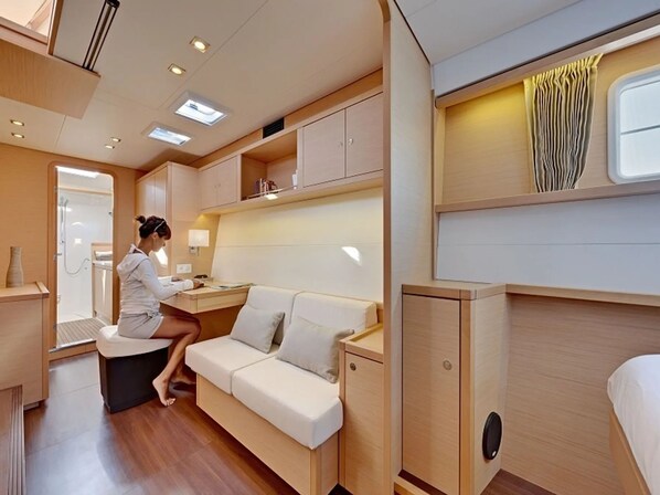 A compact, well-lit interior with a sofa, a small table, and a cabinet.