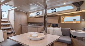 A compact interior with a kitchenette, seating area, and a window offering a view.