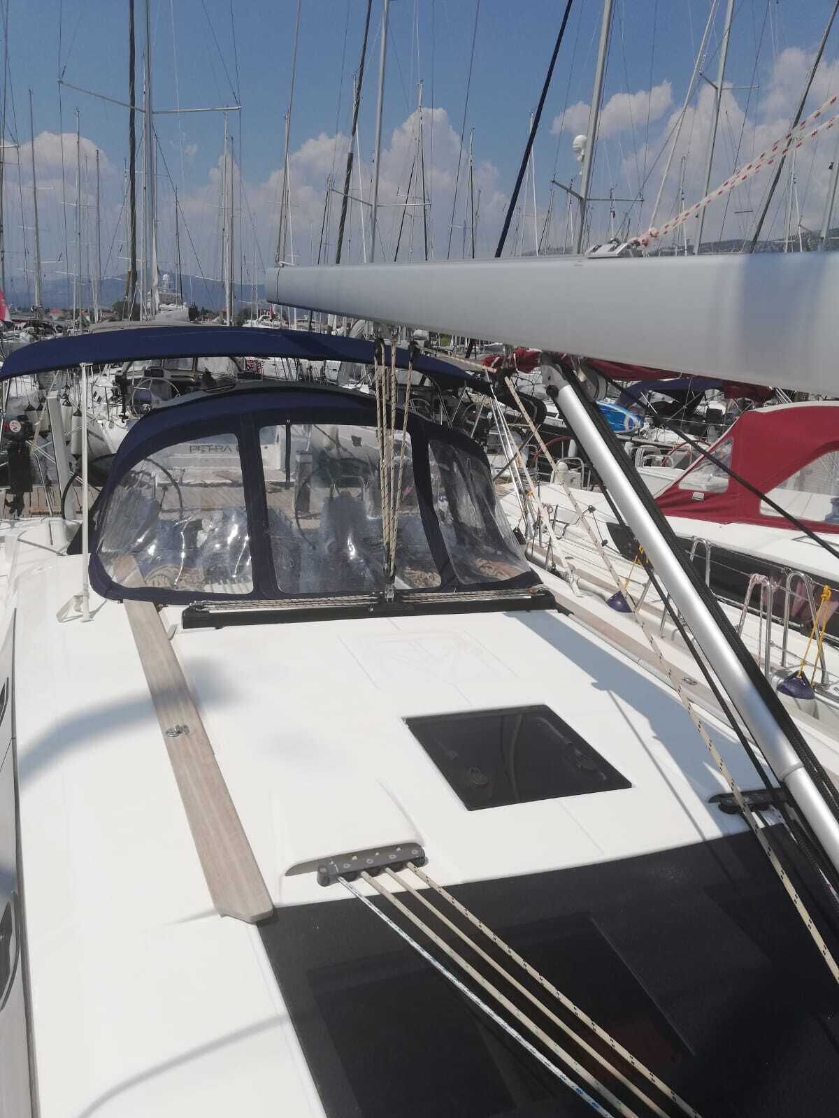 A marina with multiple sailboats docked.