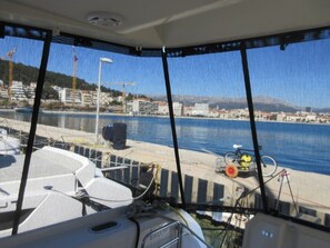 A boat's interior with a view of a marina and buildings. - Sun-Kissed Sailing Adventure in Split, Croatia (Split)