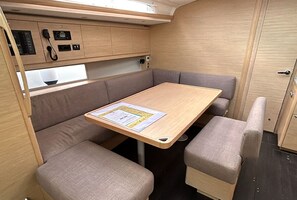 A compact kitchenette with a microwave, stove, and a small refrigerator.