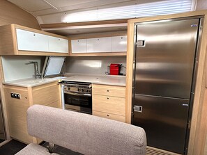 A compact kitchenette with a stove, oven, and a refrigerator.