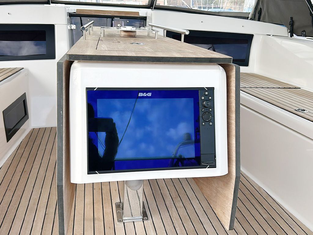 A B&G branded television mounted on a wooden deck with a clear view of the sky.