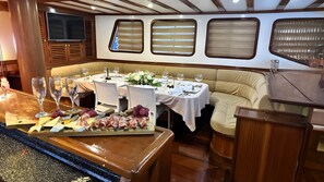 A dining area with tables, chairs, and a food display. - Sun-Kissed Sailing Adventure in Split, Croatia (Split)