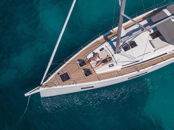 A sailboat with a deck area, a cabin, and a mast.