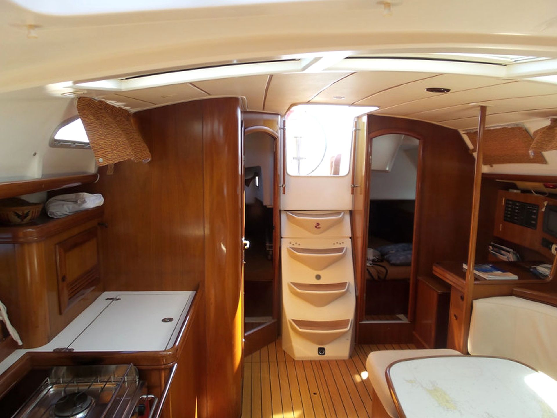 A compact galley with a stove, sink, and storage cabinets.