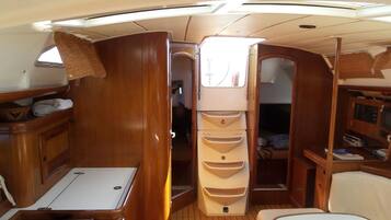 A compact galley with a stove, sink, and storage cabinets.