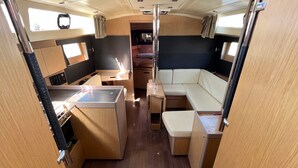 A compact RV interior with a kitchenette, seating area, and a central aisle. - Sun-Kissed Sailing Adventure in the Ionian Islands, Lefkada (Lefkada)