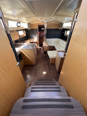 A compact RV interior with a kitchenette, seating area, and a central aisle. - Sun-Kissed Sailing Adventure in the Ionian Islands, Lefkada (Lefkada)