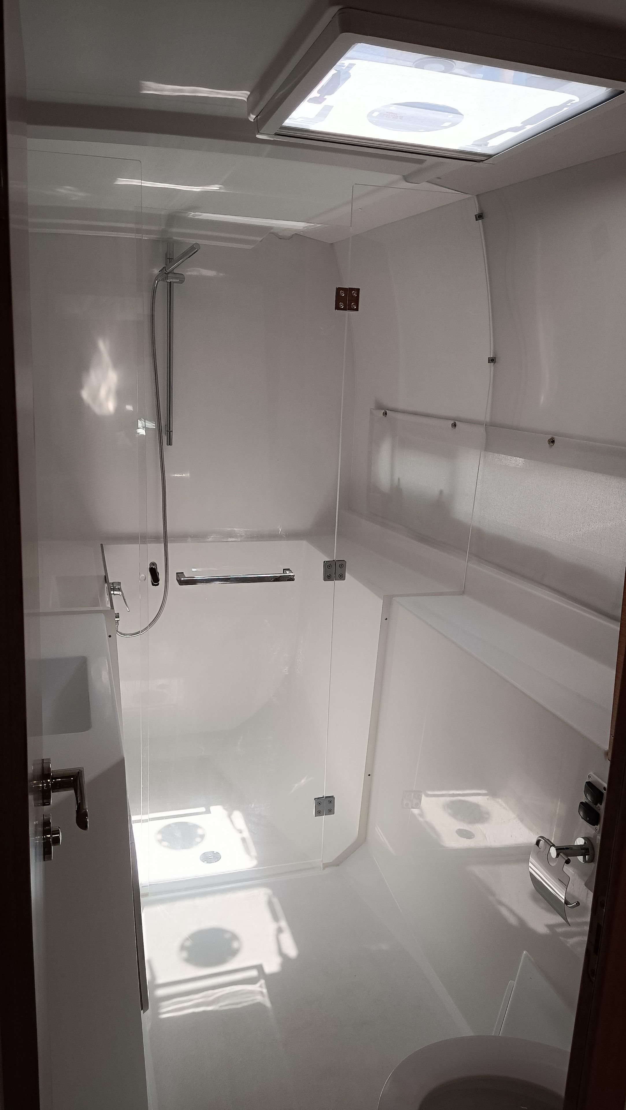 A bathroom with a shower, a toilet, and a sink.
