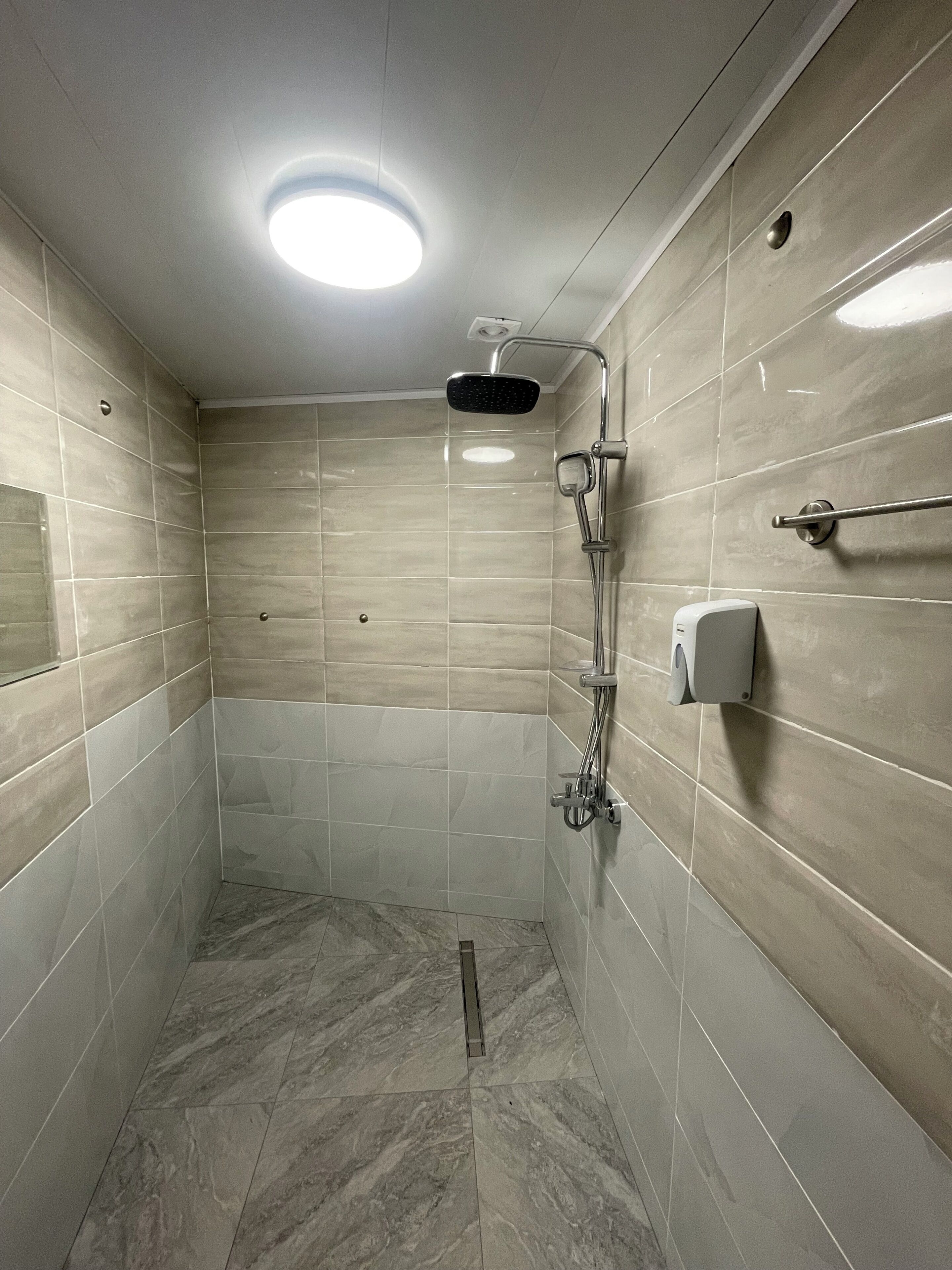 Shower, hair dryer, slippers, towels