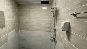 Shower, hair dryer, slippers, towels