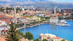 A coastal cityscape with historic buildings, a marina, and mountains in the background. - Sun-Kissed Sailing Adventure in Split, Croatia (Split)