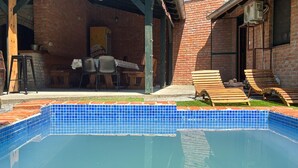 A swimming pool with blue tiles, surrounded by a brick patio. - Beautiful home in Batina with private swimming pool, can be inside or outside (Batina)