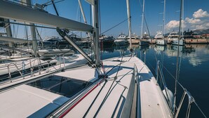 A marina with multiple sailboats docked, featuring masts, rigging, and calm water. - Sun-Kissed Sailing Adventure in Split, Croatia (Kaštel Gomilica)