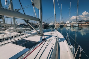 A marina with multiple sailboats docked, featuring masts, rigging, and calm water. - Sun-Kissed Sailing Adventure in Split, Croatia (Kaštel Gomilica)