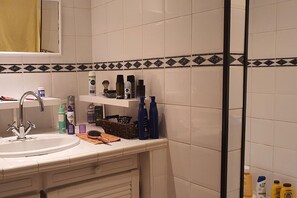 A bathroom with a sink, mirror, and toiletries on the counter. - Ground Floor of a Villa for Rent for a Dream Vacation in a Peaceful Natural Setting (Les Adrets-de-l'Estérel)