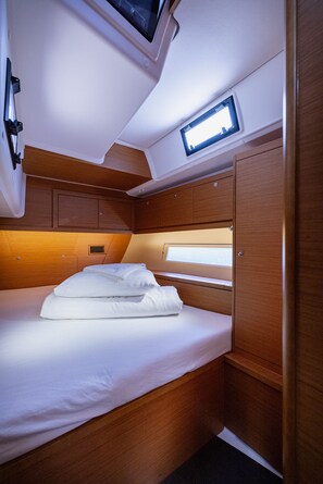 A compact, well-lit cabin with a single bed, built-in storage, and a small window for natural light. - Sun-Kissed Sailing Adventure in Split, Croatia (Kaštel Gomilica)