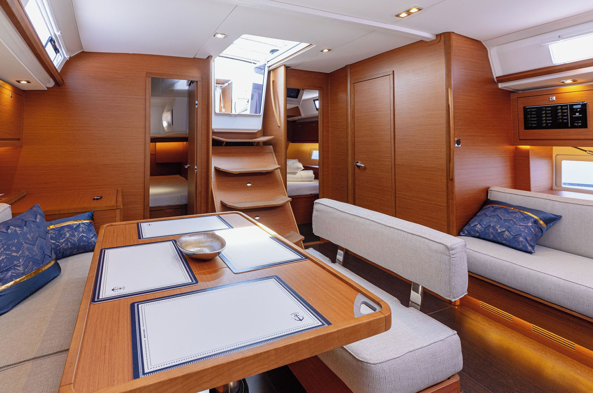 A compact, well-lit interior with a dining area, seating, and a small kitchenette.