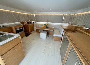 A compact kitchen with a sink, stove, and storage cabinets. - Dubrovnik Delight: A Sun-Kissed Sailing Experience (Komolac)