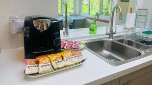 A kitchen with a coffee maker, a sink, and packaged snacks. - Coire Breac near Roy Bridge (Inverroy)