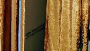A room with a wardrobe and a curtain.