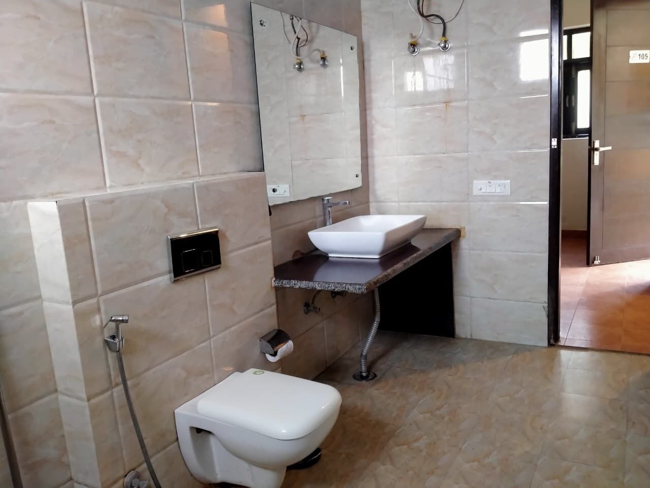 A bathroom with a toilet, sink, and shower.