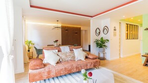 A modern living room with a sofa, coffee table, and decorative items. - Luxury Apartment • 3 Suites • 2 Parking Lots • 5 min Downtown (Strasbourg)