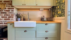 A kitchen with a sink, cabinets, and a window. - 4 Person Holiday Home in Farjestaden (Farjestaden)