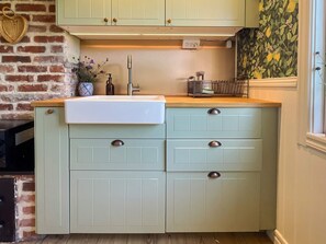A kitchen with a sink, cabinets, and a window. - 4 Person Holiday Home in Farjestaden (Farjestaden)