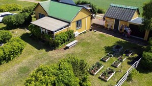 A farmstead with a large barn, a smaller structure, and a vegetable garden. - 4 Person Holiday Home in Farjestaden (Farjestaden)